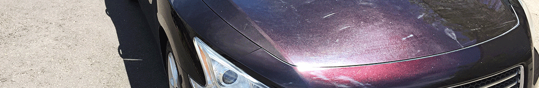 Scratched, scuffed, poorly reflective red sedan with micropolish lines before a RestorFX Paintless Clearcoat Repair treatment