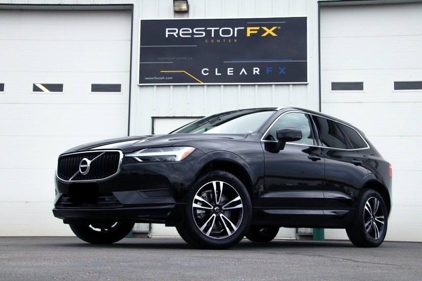 RestorFX Utah-Clearfield storefront with white building walls and a brilliantly shiny black Volvo SUV