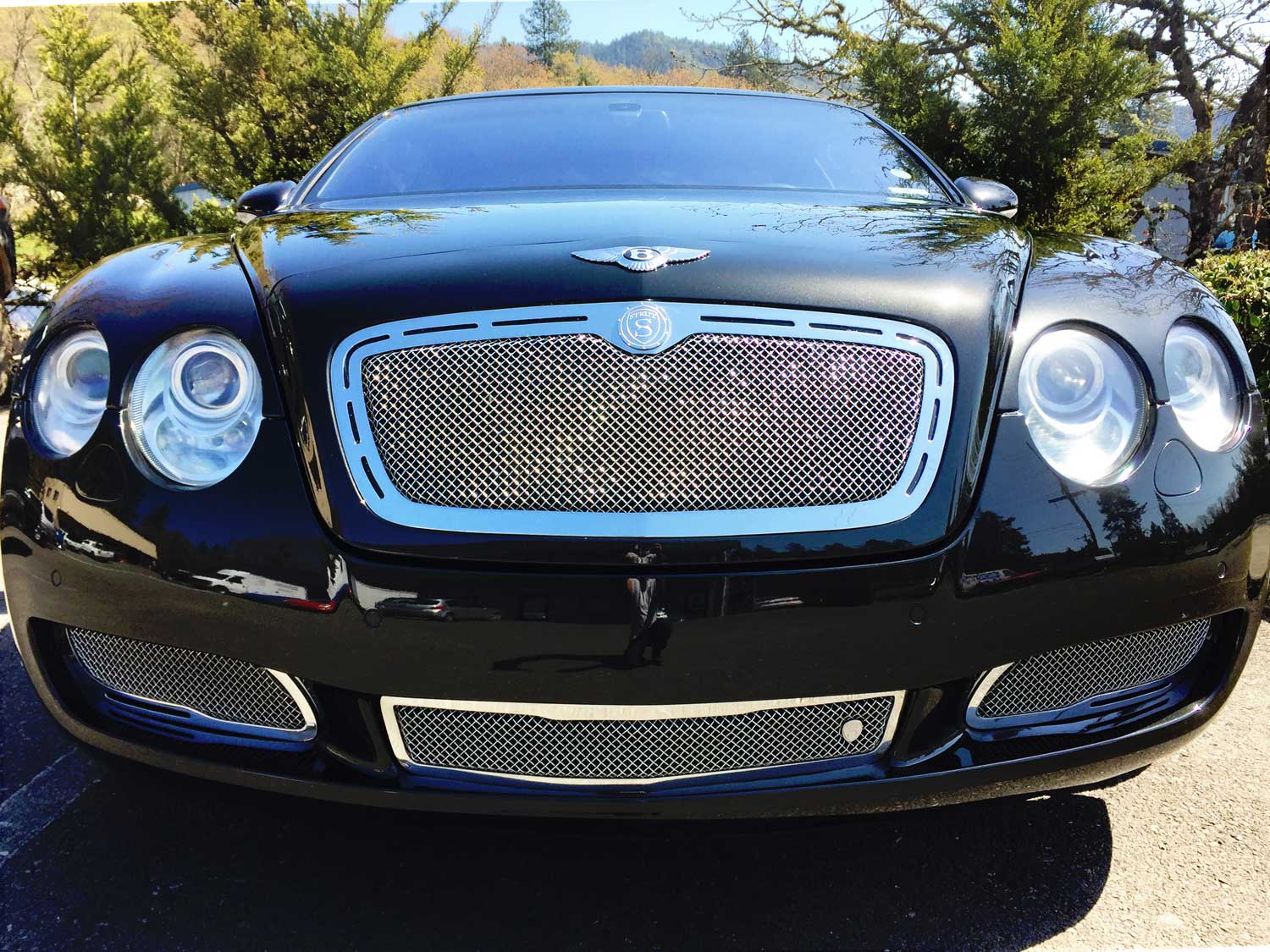 Front-view of shiny Bentley Continental GT parked at RestorFX Grants Pass center after restoration