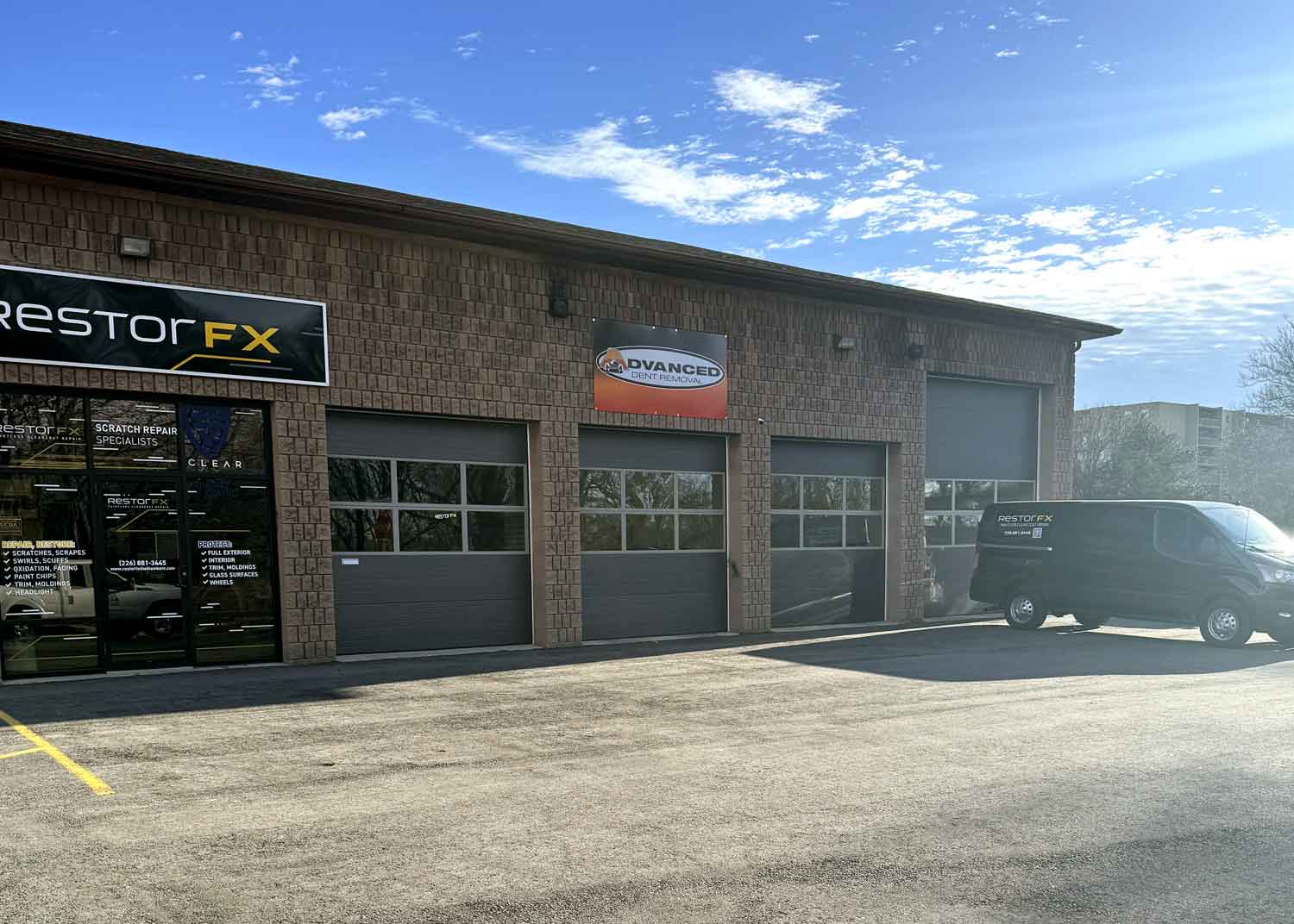 RestorFX Chatham Kent storefront with brick walls, garage doors and branded signage with black branded van parked in front