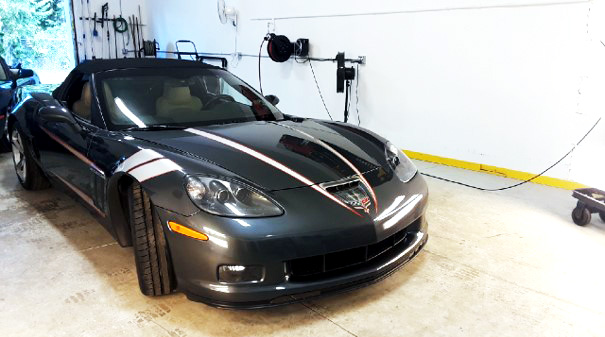 Restored and shiny Chevrolet Corvette Convertible in brightly lit shop area at RestorFX Gainesville