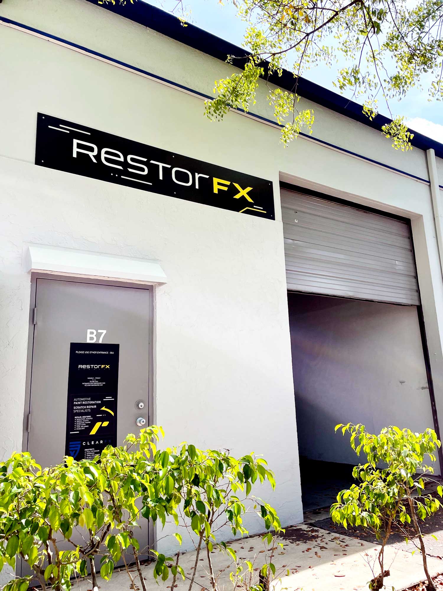 RestorFX Broward storefront with white walls, branded signage and entrance next to garage door