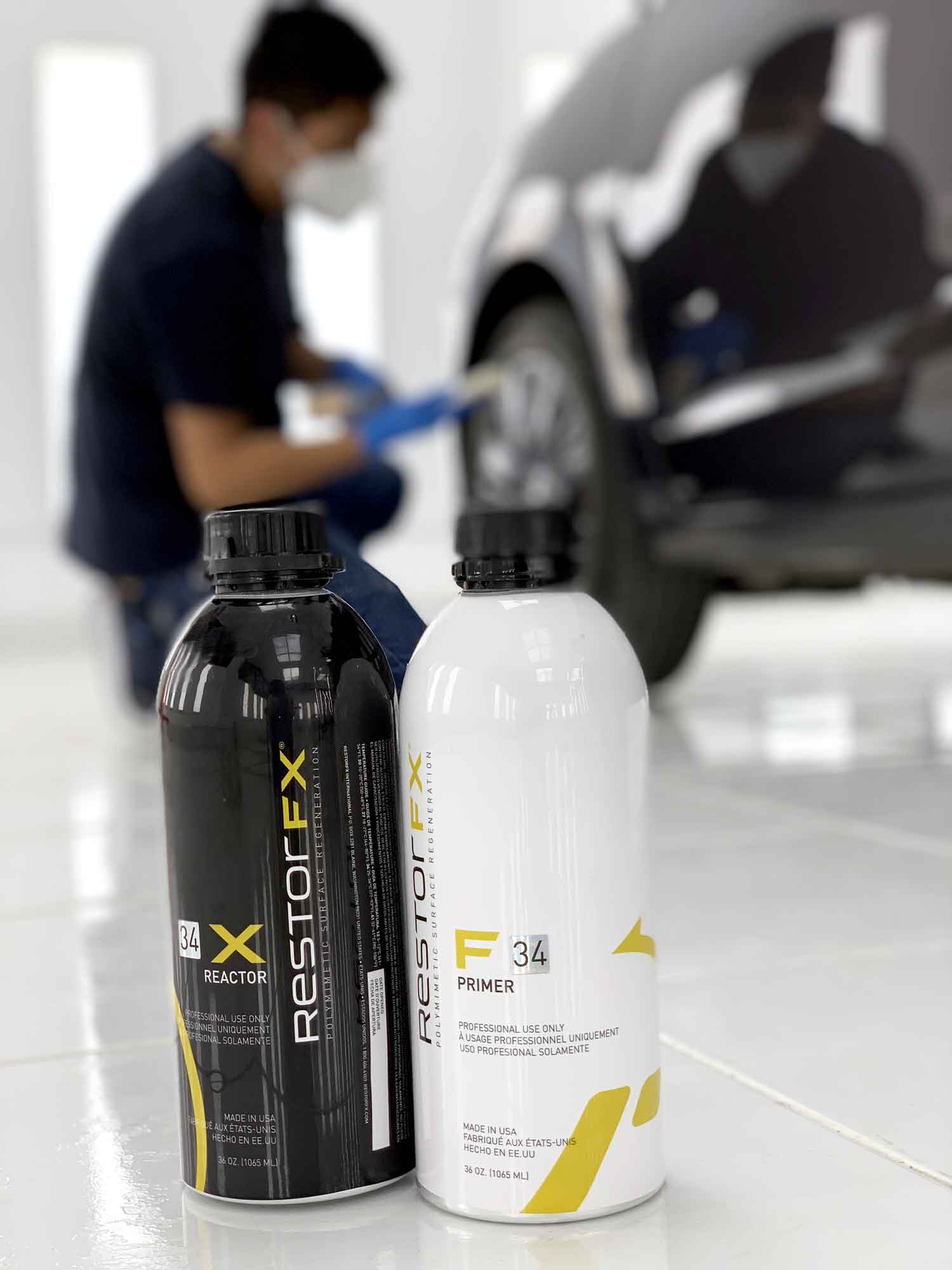 Technician applying RestorFX product onto vehicle's surface during paint restoration process