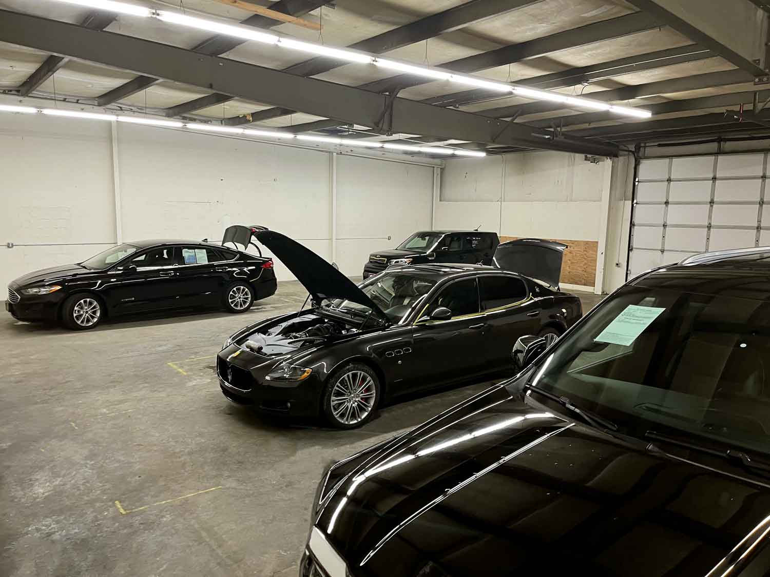 RestorFX Renton shop area with a black Bentley, black Ford and black Kia Soul
