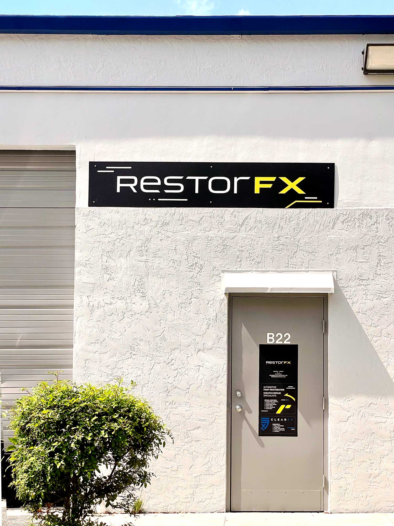 RestorFX Broward storefront with white walls, branded signage and entrance next to garage door
