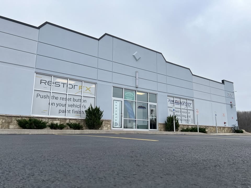 RestorFX Rochester building store front in beige and orange colors with white car parked in front