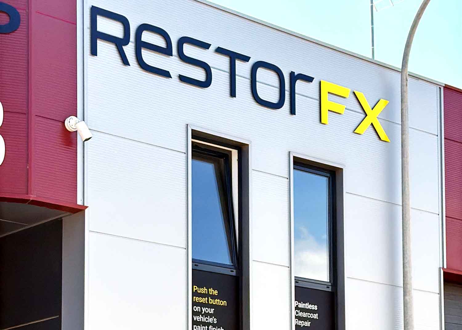 RestorFX Loule storefront with the the branded signage on windows and the exterior wall