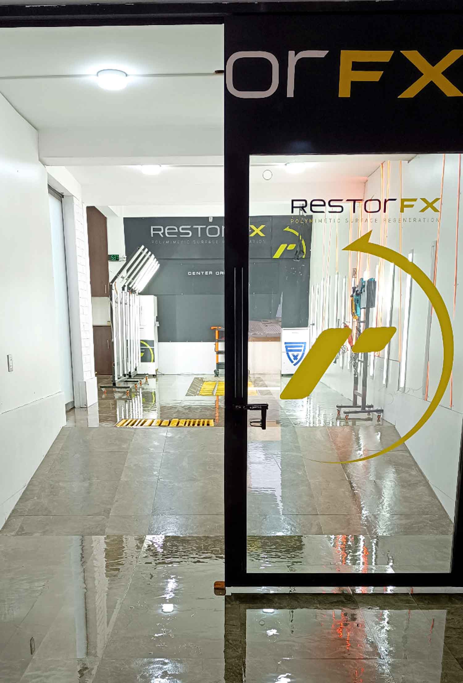 RestorFX Oruro main entrance with branded glass door and interior wall