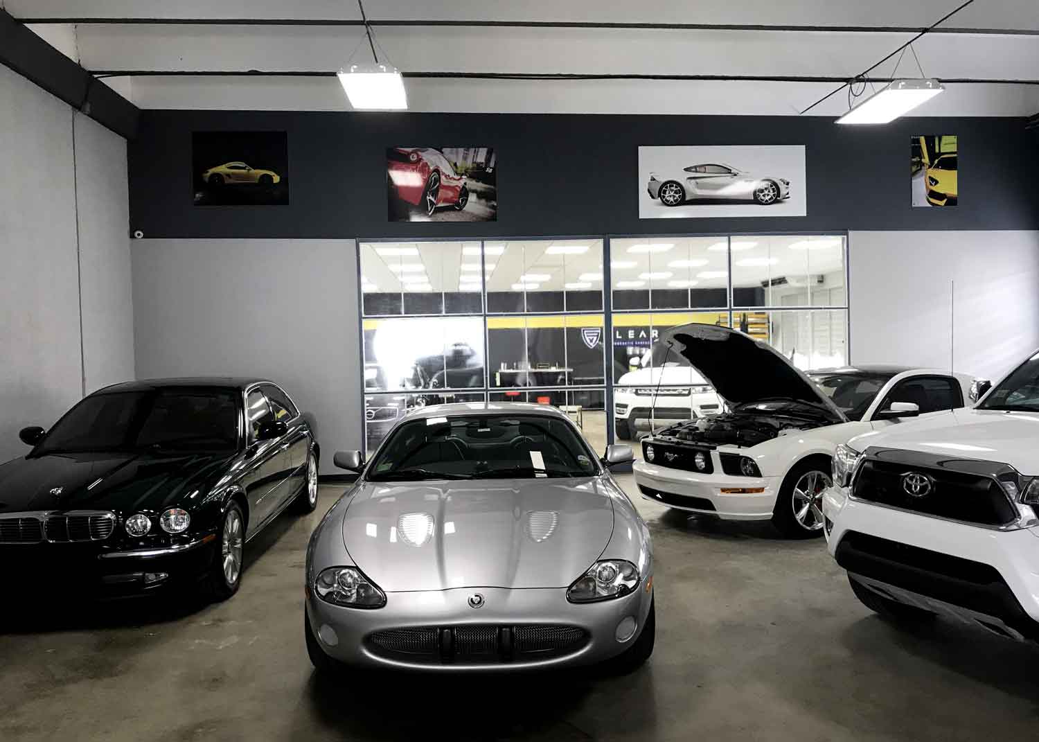 Multiple cars parked inside RestorFX Puerto Rico garage under good lighting