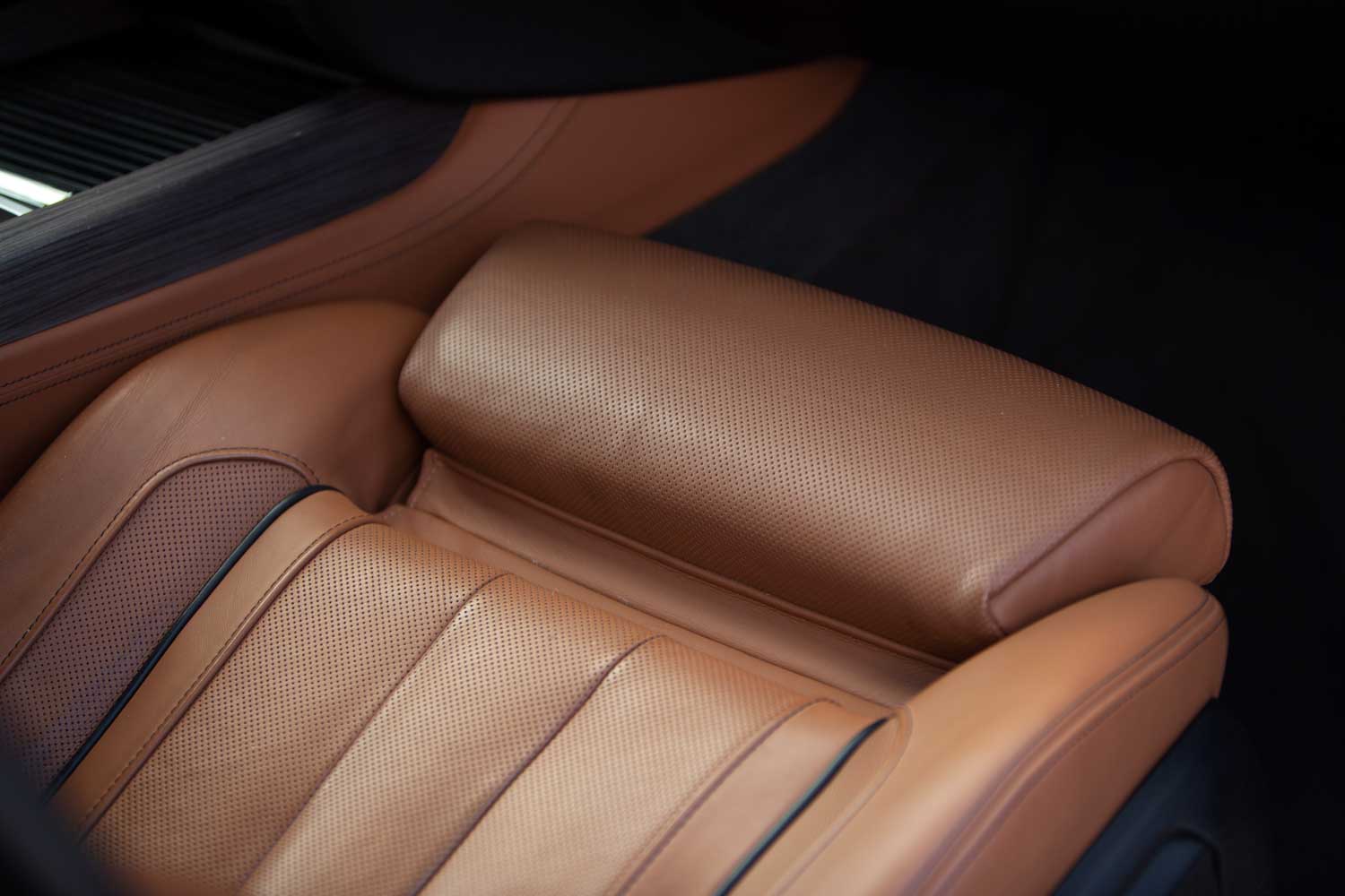 Luxury vehicle interior with brown perforated leather seats