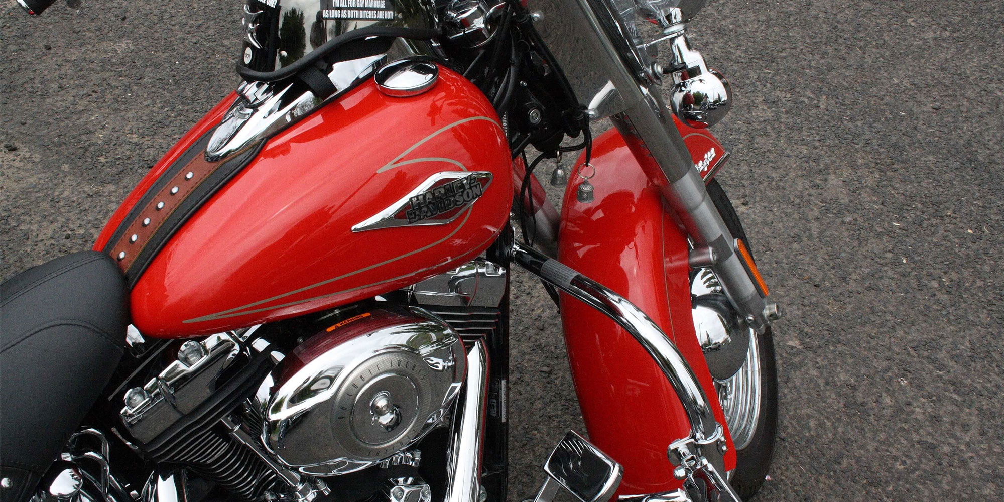 A clean and shiny motorcycle showing its brilliant red tank and fender
