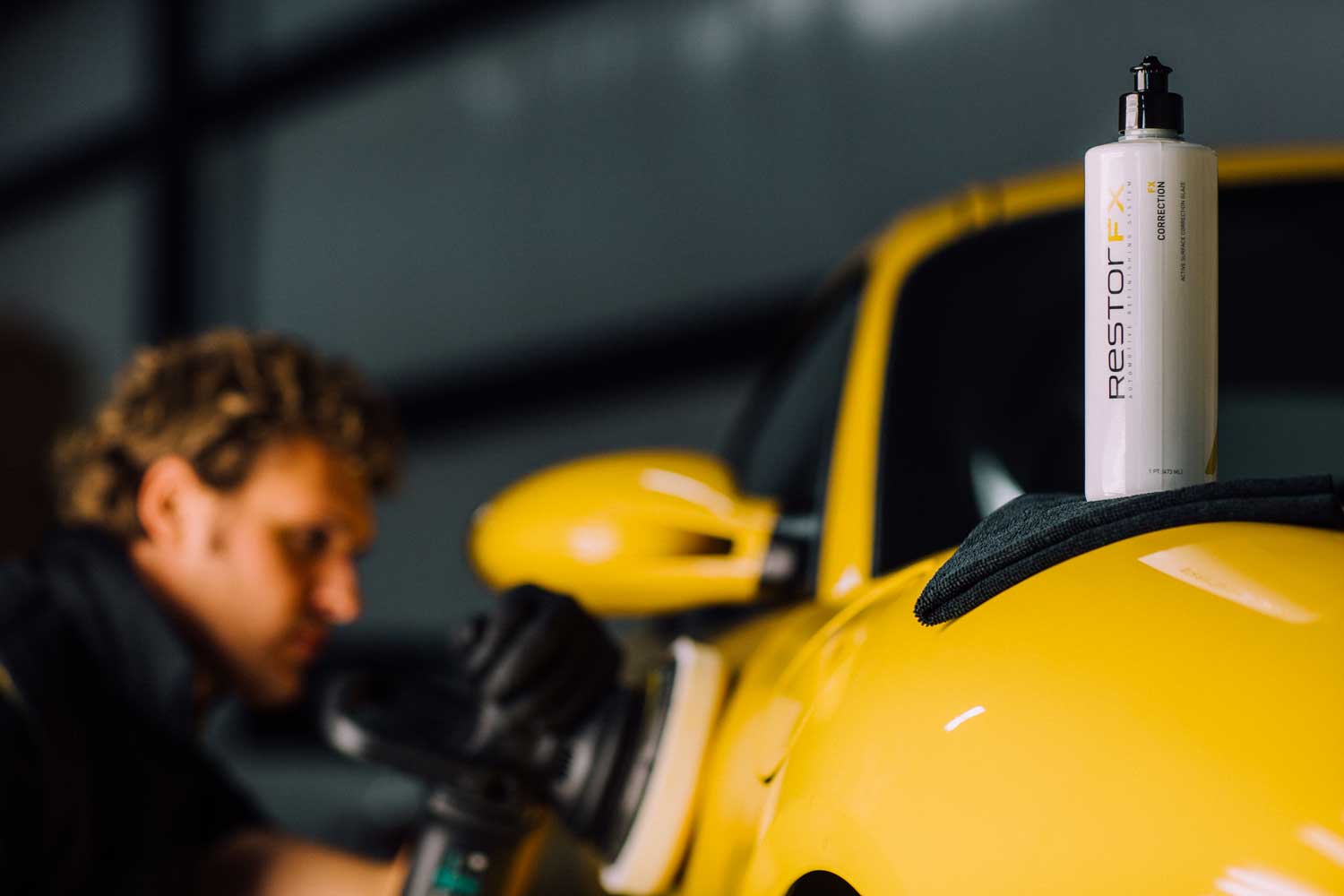 A RestorFX Technician performing light polishing on yellow vehicle paint for better shine