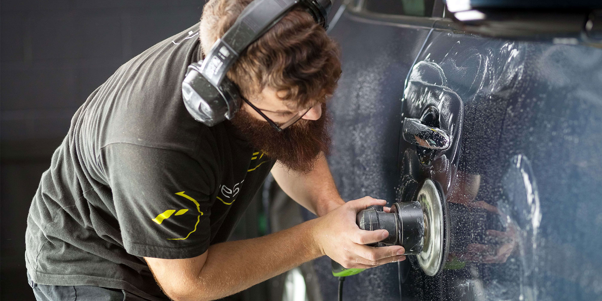 A RestorFX Technician wet sanding the side panel of a vehicle to prepare for RestorFX application